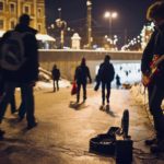 Young guitarist performing street blues in Krakow, Poland, despite freezing weather