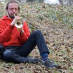 Bearded man playing a trumpet