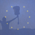 man holding a guitar with arms outstretched to the sky in front of an EU flag