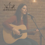 young woman playing guitar