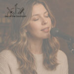 Thirtysomething woman singing into a microphone at an open mic