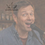 Male musician making a cheeky face playing mandolin at an open mic night