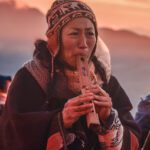 A Woman Crying while Playing Flute