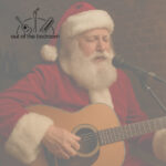 Man in Santa Claus costume playing guitar and singing sensitively at an open mic