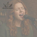 Young Scottish woman singing emotionally at an open mic