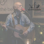 the legendary Stu Gray playing acoustic guitar and singing at Out of the Bedroom