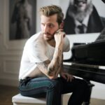 brooding male musician at piano